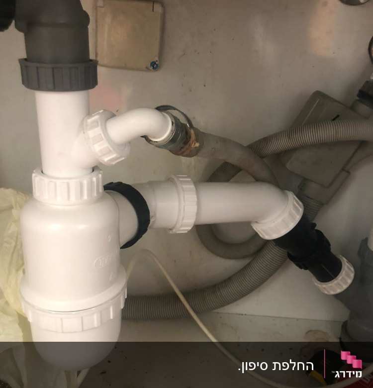 צנרת פלסטיק לבנה מתחת לכיור עם מחברים